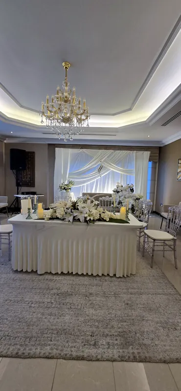 Dressed buffet table under a crystal chandelier in a reception room