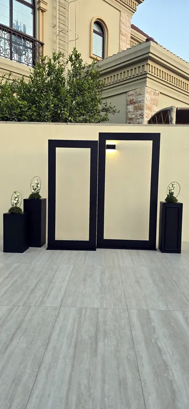 Black frame panels with plants on a villa terrace in daylight